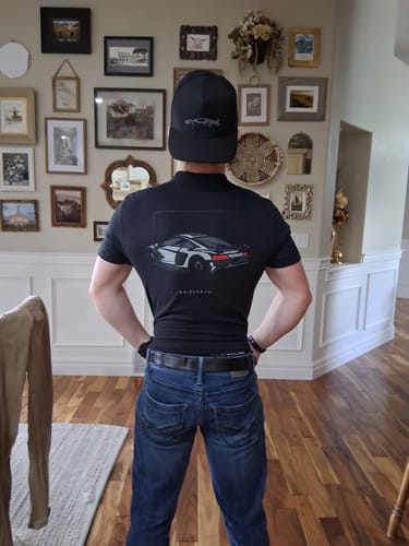Customer from behind wearing the fitted black 80Eighty® DCG89 Shirt, showing the car graphic on the back.