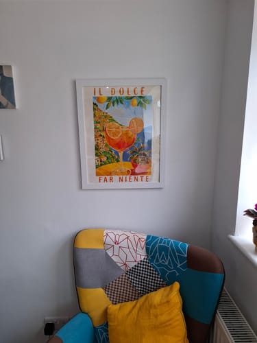 Customer's completed Aperol in Italy paint-by-numbers artwork, framed in white and hung on a wall.