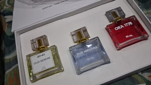 Customer's OUD Supreme BUNDLE showing the three elegant perfume bottles: Oud Serene, Oud Nirvana, and Ora 1776, in their box.