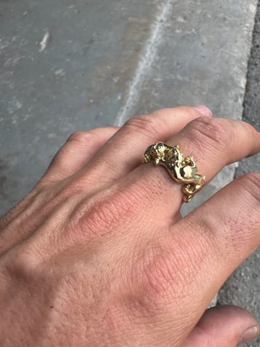 A customer's hand wearing the gold 14 K Panther Ring.