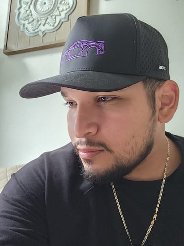 Customer wearing the black 80Eighty® DCG88 Hat with a purple embroidered car outline on the front.