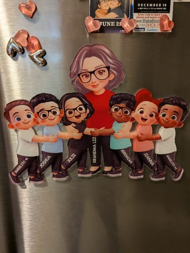 Customer's personalized acrylic fridge magnet of a grandma and six grandkids hugging, displayed on a refrigerator.