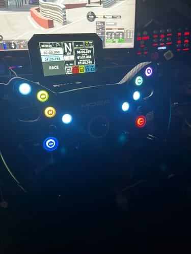Close-up of a customer's MOZA RACING KS Steering Wheel with colorful, illuminated buttons on a sim racing rig.