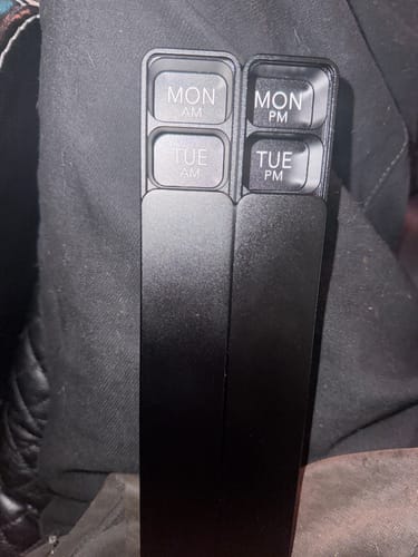 Customer's black metal Weekly AM-PM Pill Case 2.0, with the two sections separated to show the Monday compartments.