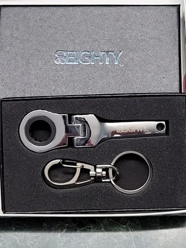 Customer's 80Eighty® 10mm Wrench Keychain displayed in its original black gift box.