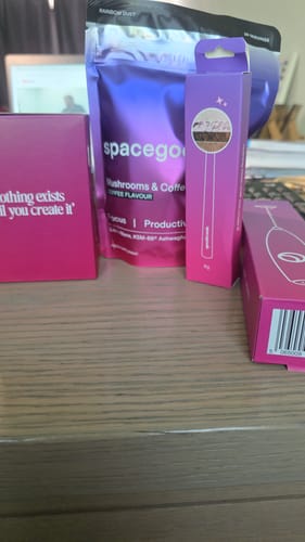 Customer's purple box for the Sexy Metal Spoon, shown on a table with other Space Goods products.
