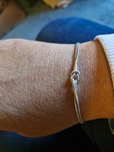 Customer wearing a silver multi-strand knot bracelet on their wrist.