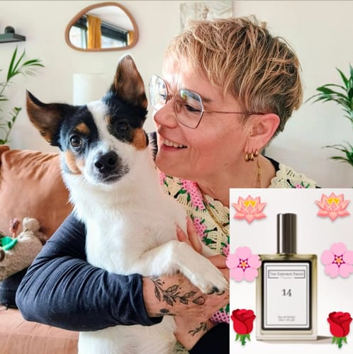 Reviewer smiling while holding a small dog, with an inset of the 'Inspired by Flowerbomb - 14' perfume bottle.