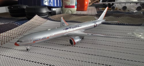 Customer's detailed GEMINI AMERICAN 777-300ER model airplane displayed on a patterned tabletop.