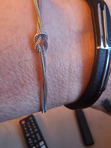 A customer's close-up view of the silver Forever Knot Bracelet on their wrist.