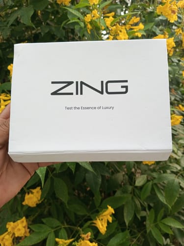 Customer holding the white box for the All-time Best Sellers Tester Pack against a floral background.