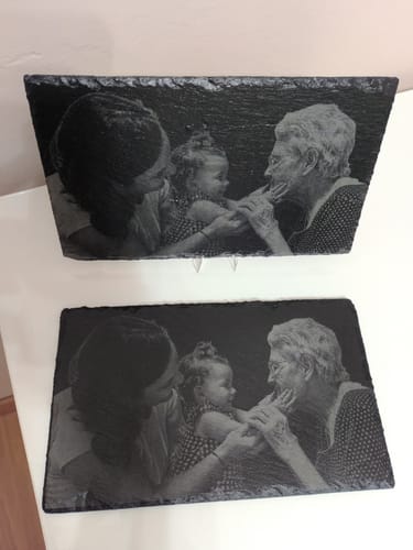 Customer shows two slate plaques laser-engraved with a family photo, made with the AtomStack Glacier engraver.
