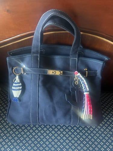 Customer's Anchor Bag Charm with colorful tassels attached to the navy boatkin bag mentioned in the review.