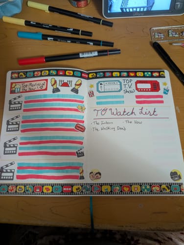 Customer's Movie Night journal spread for a 'To Watch List', decorated with colorful movie-themed stickers and washi tape.