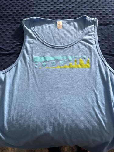 Customer's light blue 80Eighty® Azure Tank laid flat, showing the colorful graphic on the chest.