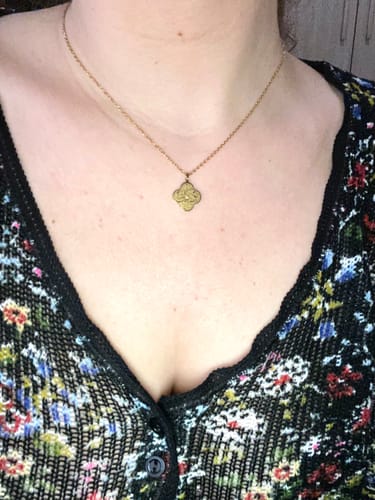 Customer wearing the gold Trust in God Necklace, shown in a close-up on their chest.