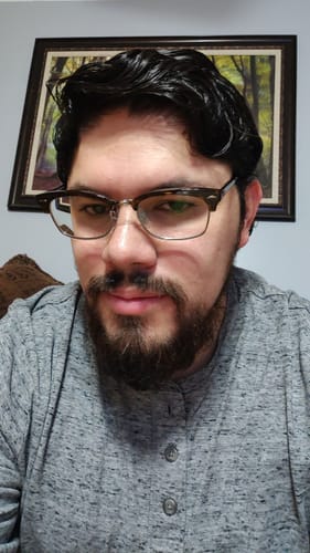 Customer's photo showing them in a grey shirt and glasses.