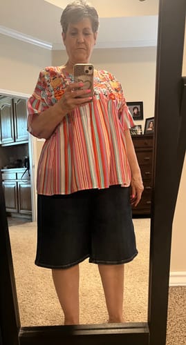 Reviewer in a mirror selfie wearing the dark wash Judy Blue High-Waist Jorts which fall just above the knee.