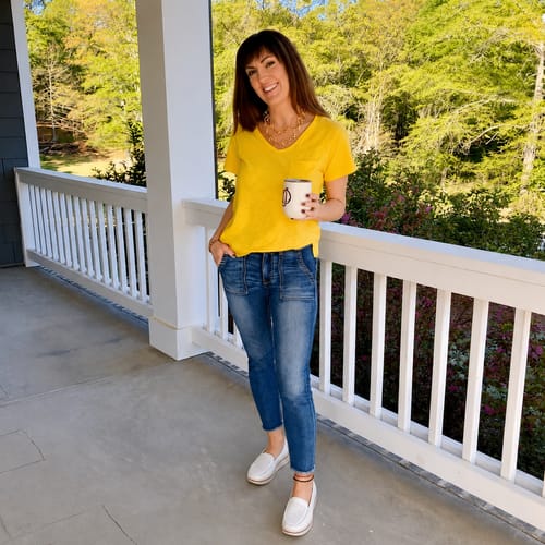 Customer wearing white Soleva loafers with cuffed jeans and a yellow shirt, showcasing a casual style.