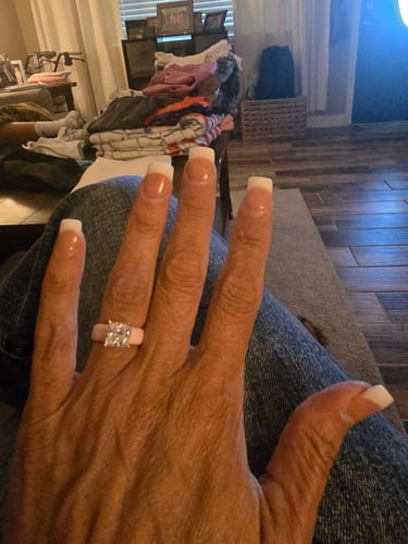 Reviewer's hand wearing the pink Silicone Ring, showing the large princess-cut CZ stone.