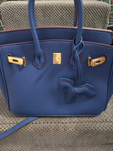 Customer's blue Leather Horse Charm shown attached to a matching blue handbag with gold hardware.