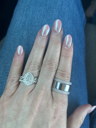 Reviewer's hand wearing the light gray StyleFit Protector over a silver smart ring on their middle finger.