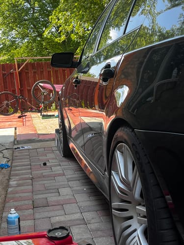 Customer's black car showing rear wheel fitment after installing the 20mm Wheel Spacers.