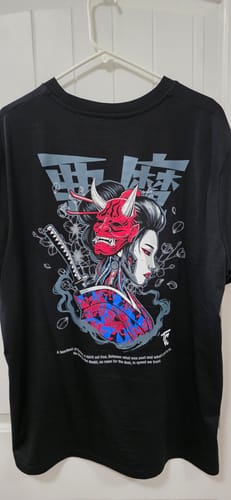 Customer's black DARK GEISHA TEE on a hanger, displaying the back graphic of a geisha with a red Oni mask.
