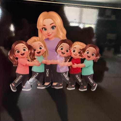 Customer's personalized acrylic fridge magnet showing cartoon illustrations of a grandma and five grandkids hugging.