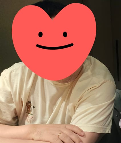 Reviewer wearing the pale yellow That Sunday Feeling T-Shirt, showing its relaxed fit and chest graphic.