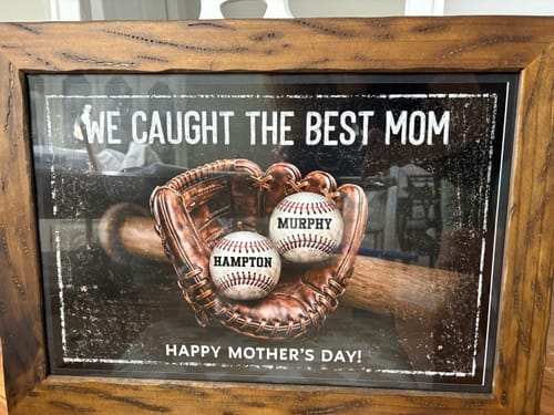 Customer's framed 'We Caught The Best Mom' personalized poster showing a glove holding two custom baseballs.