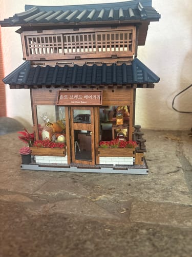 Customer's detailed, assembled Ikseon-dong Hanok Bakery kit shown unlit on a surface.