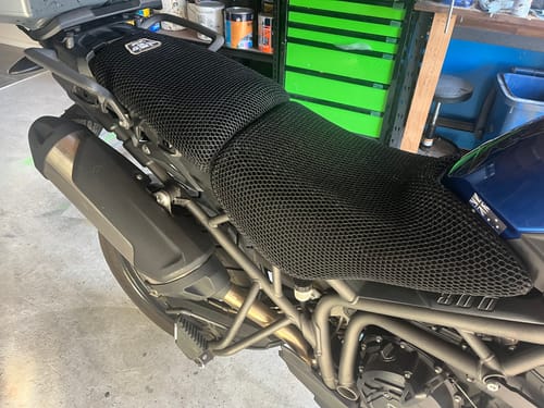 Customer's black mesh Wind Rider Seat Cover installed on the two-tiered seat of their Triumph motorcycle.