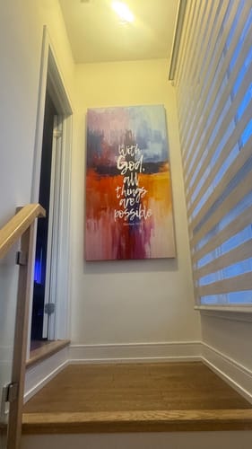 Customer's 'With God All Things Are Possible' canvas art hanging on a wall at the top of a staircase.