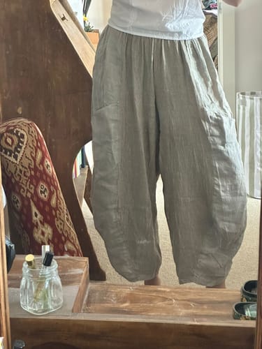 Reviewer showing the relaxed, wide-leg fit of the light-colored Meo Linen Barrel Pant.