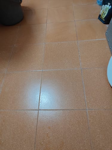 Customer's image of a brown tiled floor, the charging cable is not shown.