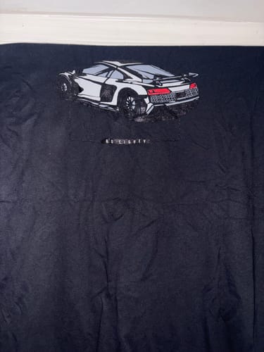 A customer's black 80Eighty DCG89 Shirt laid flat, showing the white sports car graphic.