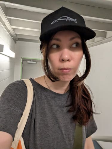 A reviewer wearing the black 80Eighty DCG89 Hat indoors, showing how it fits.