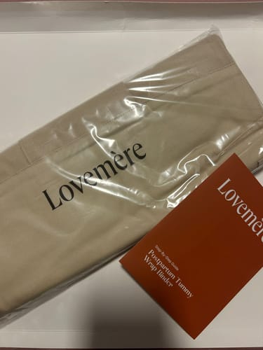 Customer's Lovemere Postpartum Tummy Wrap Binder in its clear packaging with the instruction booklet.