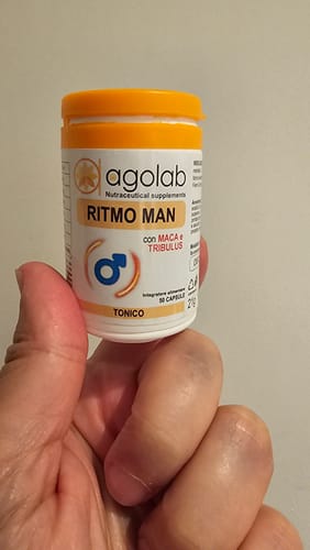 Recensore che tiene in mano un flacone bianco di integratori Agolab Ritmo Man.