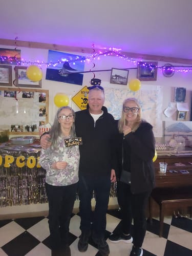 Customer and two people celebrating at a 75th birthday party.