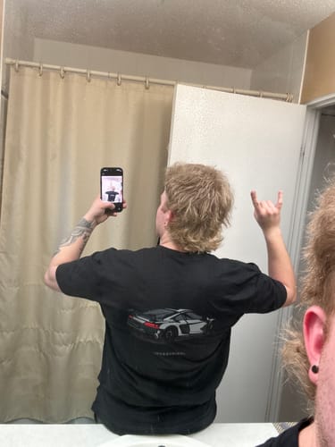 Customer showing the back of the black 80Eighty DCG89 shirt in a mirror selfie.