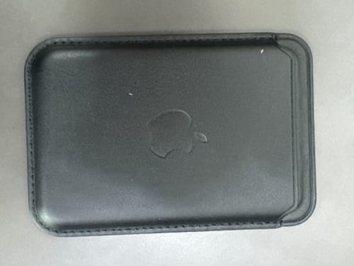 Customer's black Signature Leather Magsafe Wallet for Iphone lying flat on a surface.