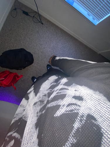 Close-up of a reviewer wearing the Skeleton Graphic Waffle Sweatshirt, with the print partially seen through shadows.