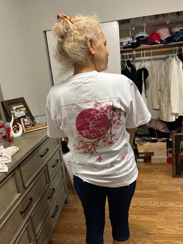 Reviewer wearing the white Spring Blossom T-shirt, showing the cherry blossom print on the back.