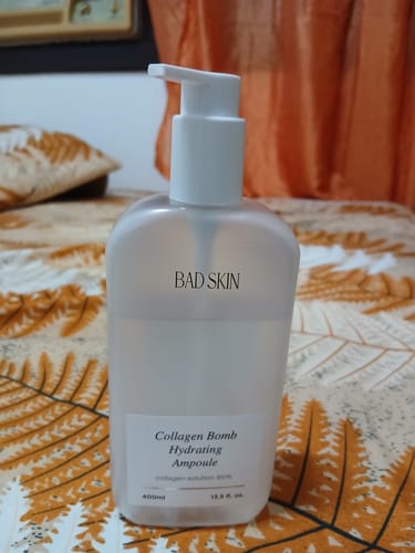 Reviewer's frosted pump bottle of Bad Skin Collagen Bomb Hydrating Ampoule.