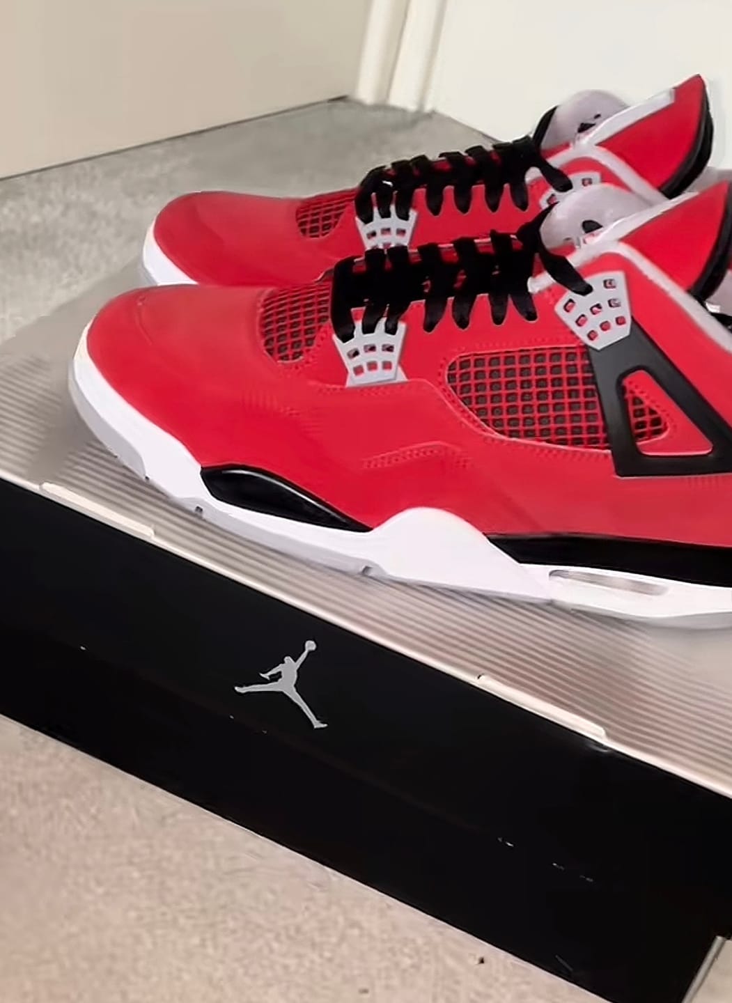 Customer photo review of Air Jordan 4 "Toro Bravo" Fire Red and Black