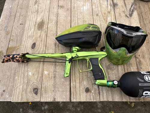 Customer's lime green Powerhouse Counterpunch Regulator shown on a matching paintball marker and tank setup on a wooden table.
