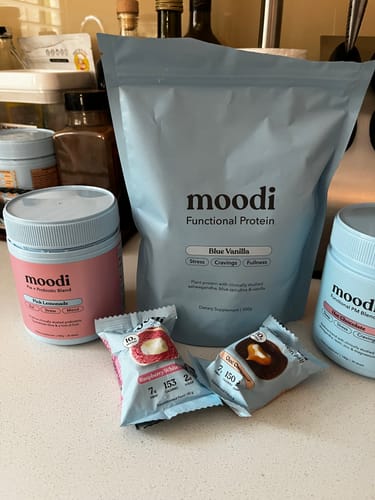 Customer's Blue Vanilla protein bag displayed with other products from their protein bundle on a kitchen counter.