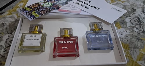 Customer displays their Nanga Parbat perfume, a blue liquid, alongside two other scents in a box.